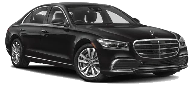 Black Mercedes S-Class sedan on city street